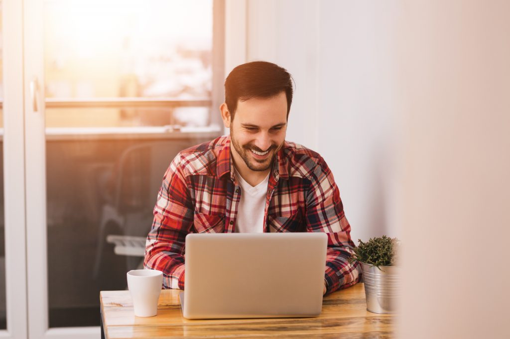 Successful,Entrepreneur,Smiling,In,Satisfaction,As,He,Checks,Information,On
